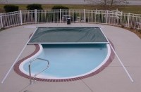 Automatic swimming pool cover with track